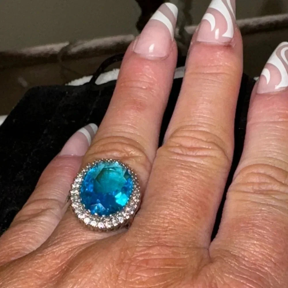 Striking oval 9 carat ocean blue topaz with a cz halo Sterling silver size 7